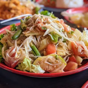 E8. Tum Sua. $9. Green papaya salad with fermented fish sauce and vermicelli.