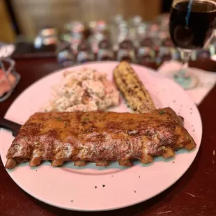 a plate of ribs and coleslaw