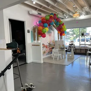 a room with a bunch of balloons hanging from the ceiling