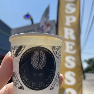 a hand holding a cup of coffee