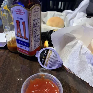 Empty steak sauce bottle, whipped spread, runny ketchup and over spiced fries covered in who knows what