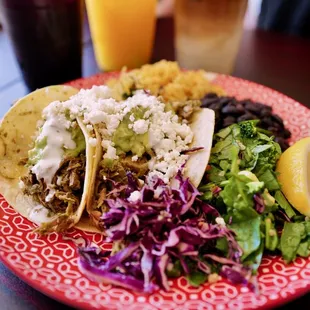 a plate of tacos and salad