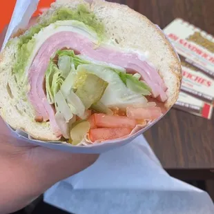 a person holding a sandwich