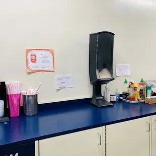 Sauces, utensils, napkins straw area next to pick up window.
