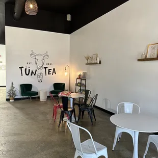 tables, chairs, and artwork on the wall