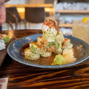 a plate of sushi and a glass of water