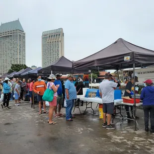 a large group of people standing under tents