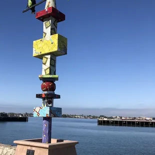 a colorful birdhouse on a pole