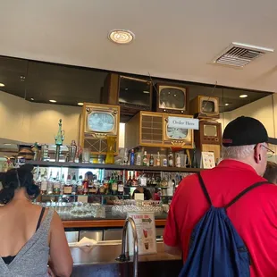 a man and a woman sitting at a bar