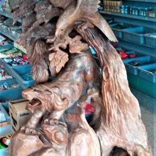a wooden sculpture of a bear and a bear cub