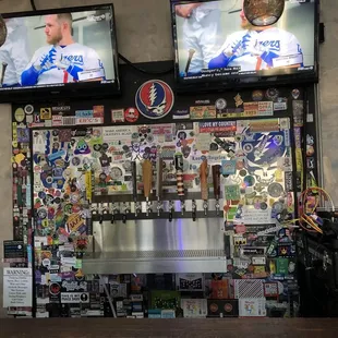a bar with several televisions above it