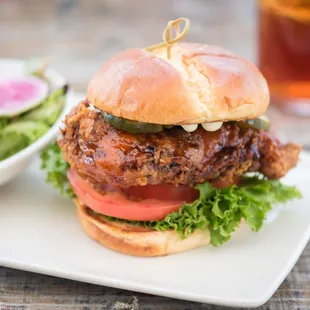 a chicken sandwich with a side salad