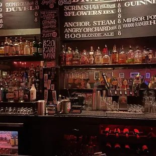 a bar with a lot of bottles of alcohol