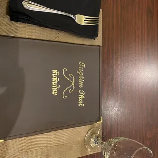 a menu and a wine glass