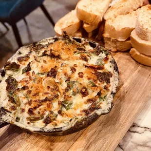 a close up of a pizza on a cutting board