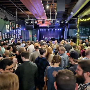 a large group of people standing in a room