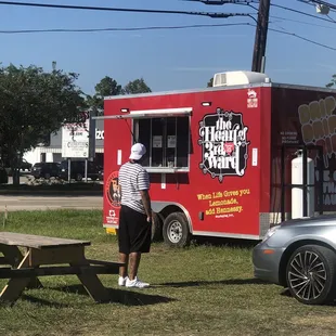 a man standing in front of a food truck