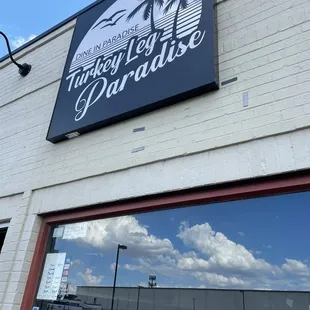 a reflection of a palm tree in the window