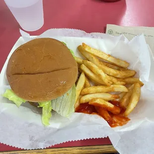 A Burger with partially eaten fries for roughly $8.00.