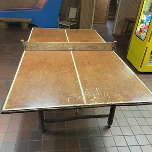 Arcade downstairs with a wood net ping pong table