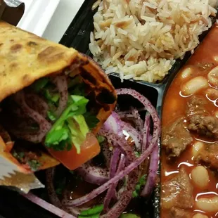 a plate of food with rice, beans, and meat