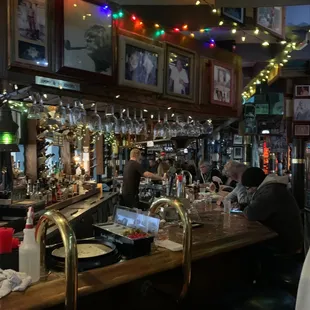 a bar with people sitting at the bar