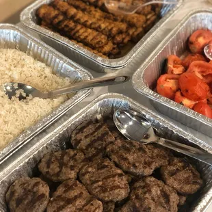 Rice, Chicken Adana Kebab, Barbecued Meatballs, and Grilled Tomatoes.