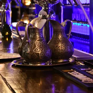 a close up of a teapot and a plate on a bar