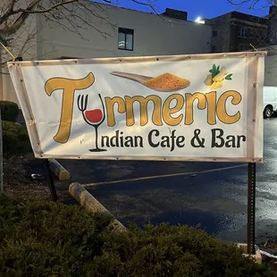 a sign for turmeric indian cafe and bar