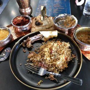 L to R Fruit Bango, chef&apos;s 65, naan, Chicken Nizami Dum Biryani, and chicken Kadai curry. The drink was Rose Milk