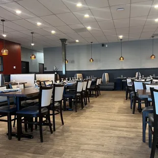 a dining area with tables and chairs