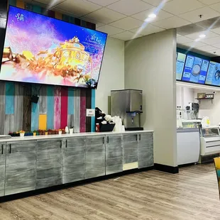 a restaurant with a large screen