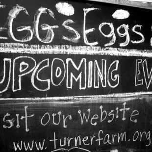 a chalk board with a sign that says eggs eggs upcoming