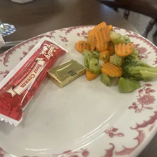 Steamed veggies and the plastic tube of sour cream...