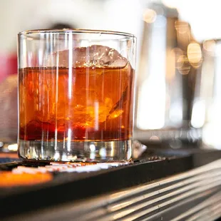a glass of whiskey on a bar
