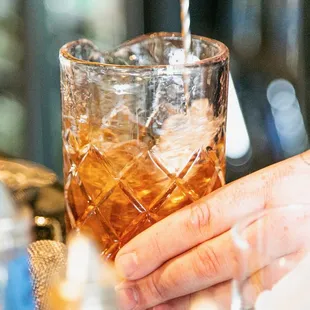 a bartender pouring a drink