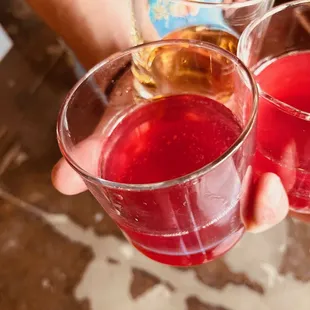 two people holding glasses of wine