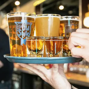 a tray full of beer glasses