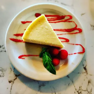 Classic New York Cheesecake with a raspberry drizzle