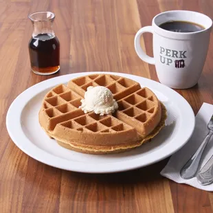 a plate of waffles and a cup of coffee