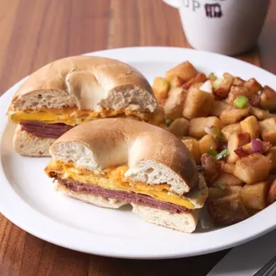 a breakfast sandwich and potatoes