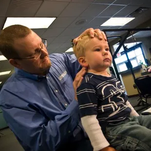 Dr. Linn adjusting a toddler