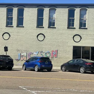 three cars parked in front of a building