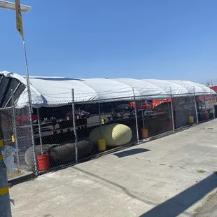 Tented dining area seen from street.