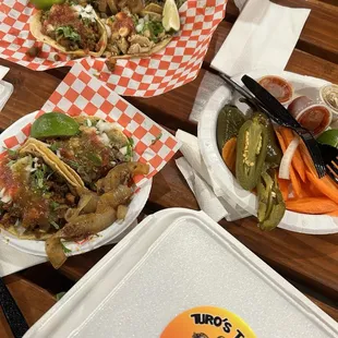 Bottom left corner al pastor and carne asada tacos, cheese fries bottom right corner.