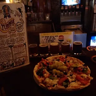 Turoni's small house special pizza with a flight of their home-made brews