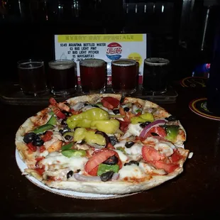 Turoni's small house special pizza with a flight of their home-made brews