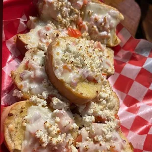 More of a garlic bread with tomatoes &amp; different cheeses on top.
