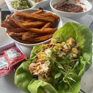 Turquesa Lobster roll &amp; sweet potato  fries.   Background: chips, guacamole  &amp; salsa.