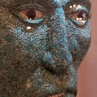 Turquoise mask in exhibit.